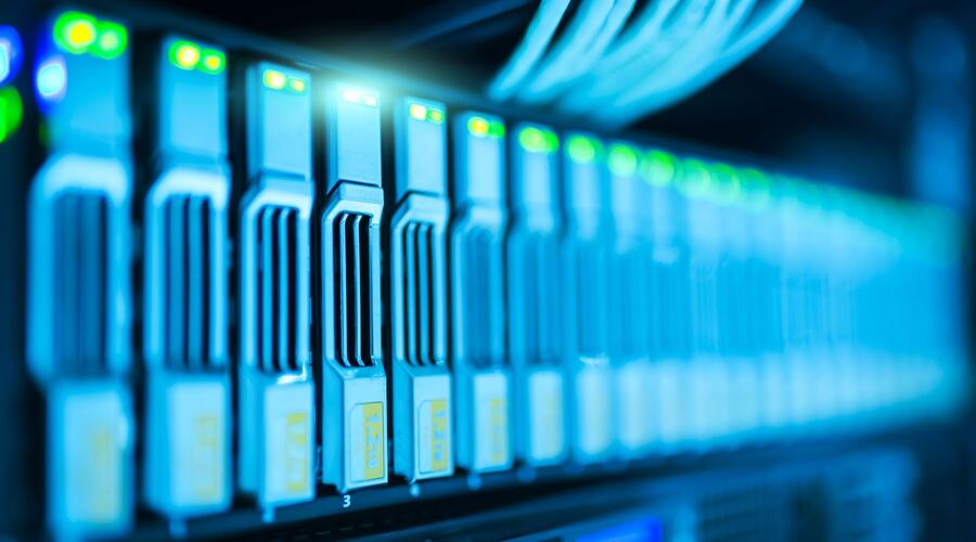 Rows of lit network equipment in a data centre